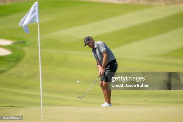 Charl Schwartzel of South Africa pitches onto the green on hole 7 during the second round of the International Series Oman at Al Mouj Golf on...