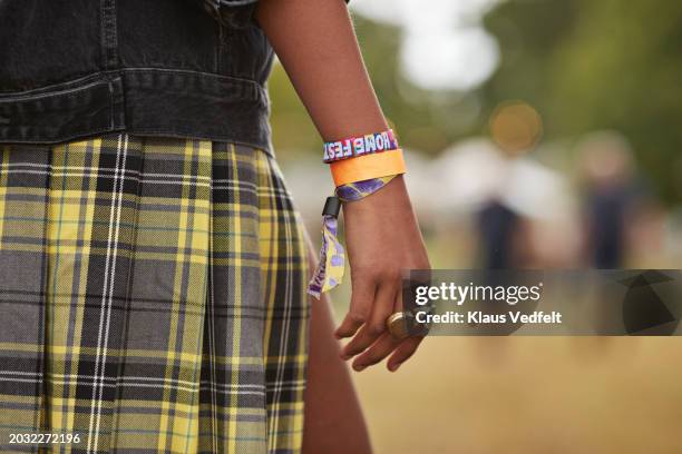 woman wearing wristbands and rings - bracelet festival stock-fotos und bilder