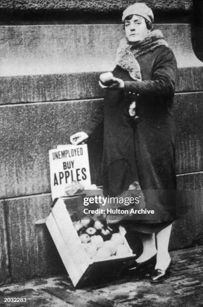 Unemployed woman selling apples during the Depression; New York City, New York, 1929.
