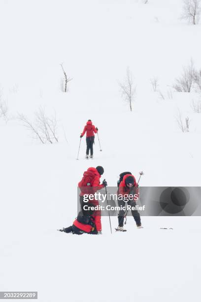Vicky Pattison, Alex Scott and Laura Whitmore during the final day of the 'Snow Going Back' challenge helping Sara Davies up from a stumble on the...
