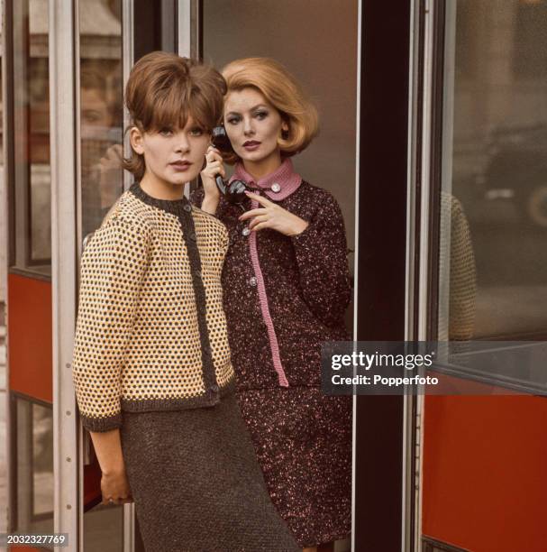 Two female fashion model posed wearing outfits for the Autumn season with, on left, a grey, white and yellow collarless button up jacket top and...