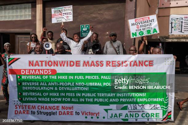 Protestors hold a banner during the Joint Action Front and the Coalition for Revolution nationwide protest against the government policies of...