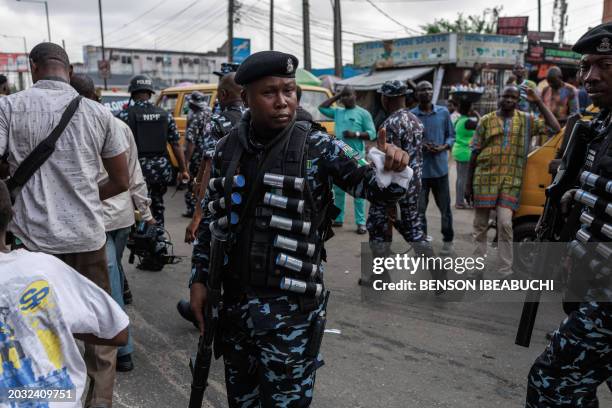 Nigerian anti-riot policemen are deployed during the Joint Action Front and the Coalition for Revolution nationwide protest against the government...