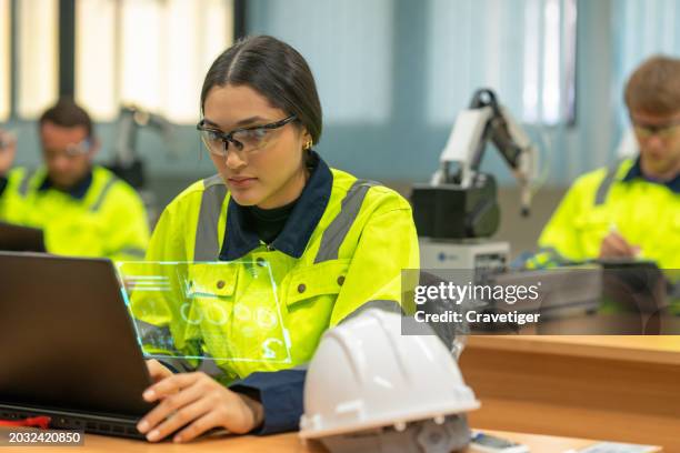 the robotics engineer is writing the ladder stepping through functions of programmable logic controller for control the robotics arm in the laboratory of robotics academy. upskill concepts. - perfeccionamiento profesional fotografías e imágenes de stock