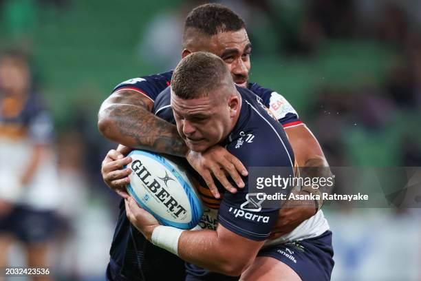 Blake Schoupp of the Brumbies is tackled by Lukhan Salakaia-Loto of the Rebels during the round one Super Rugby Pacific match between Melbourne...