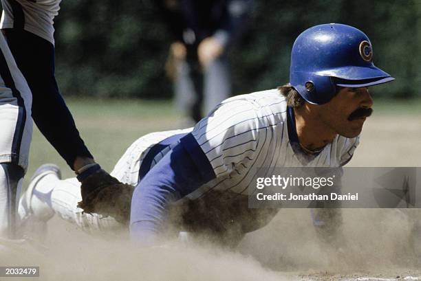 Bill Buckner of the Chicago Cubs slides across a base during a game in the 1980 season at Wrigley Field in Chicago, Illinois .