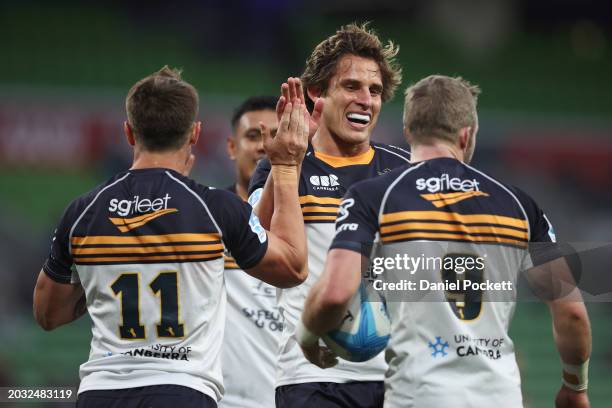Corey Toole of the Brumbies celebrates scoring a try with Ollie Sapsford of the Brumbies and Ryan Lonergan of the Brumbies during the round one Super...