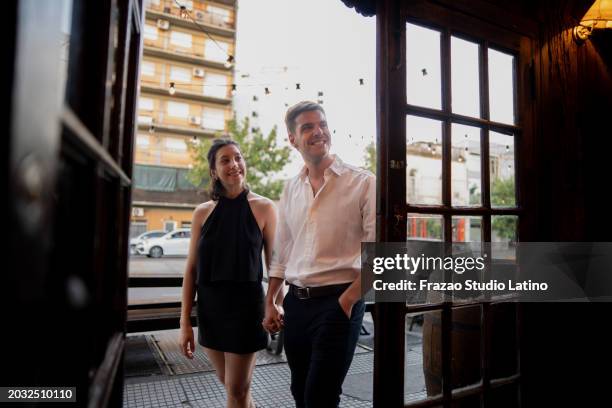 couple entering a restaurant - entered stock pictures, royalty-free photos & images