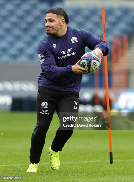 Sione Tuipulotu runs with the ball during the Scotland Captain's Run ahead of the Guinness Six Nations 2024 match against England at BT Murrayfield...