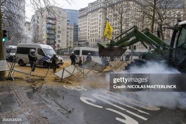 A tractor breaks true the police barricade during a protest action of farmers' organizations 'Federation Unie de Groupements d'Eleveurs et...