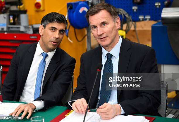 Britain's Prime Minister Rishi Sunak and Britain's Chancellor of the Exchequer Jeremy Hunt speak during a cabinet meeting at a factory, in East...
