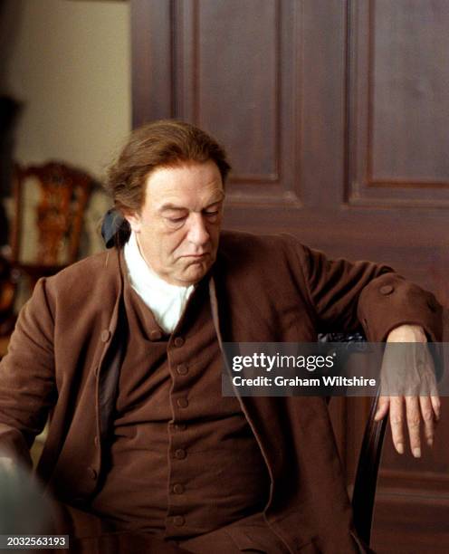 Actor Michael Gambon in costume on set during a break in filming for the television drama 'Longitude', 1999.