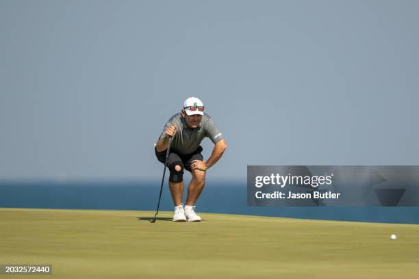 Louis Oosthuizen of South Africa lines up his putt on hole 11 during the second round of the International Series Oman at Al Mouj Golf on February...