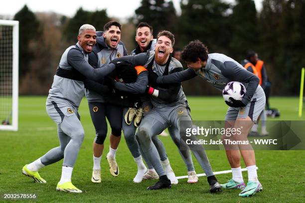 Mario Lemina, Pedro Neto, Pablo Sarabia, Jose Sa and Hugo Bueno of Wolverhampton Wanderers try to get Nelson Semedo to pose for a photo with them...