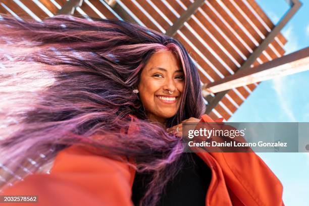 hippie woman with purple hair and nose piercing smiling at camera - cabello morado fotografías e imágenes de stock