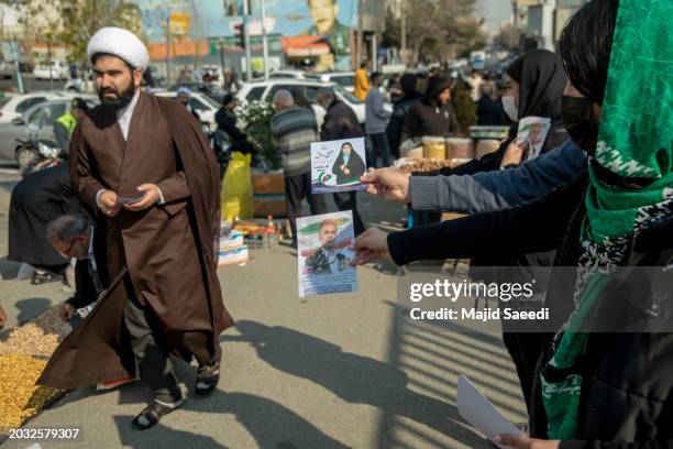 Iranians are seen broadcasting the photos and advertisements of Iranian parliament candidates after Friday prayers in Mosli, on February 23 in...