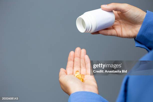 closeup photography of woman hands,shaking on the hand pills from blank jar. - ace bandage stock pictures, royalty-free photos & images