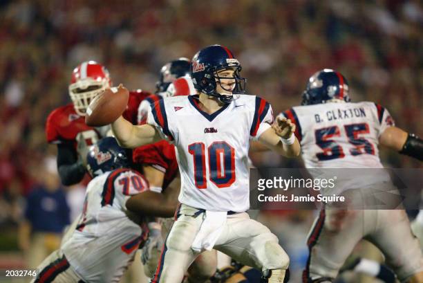 Quarterback Eli Manning of the University of Mississippi Rebels attempts to pass the ball during the SEC game against the University of Georgia...