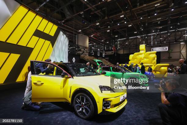 Attendees look at the Renault SA R5 E-Tech city car after its unveiling on the opening day of the Geneva International Motor Show in Geneva,...