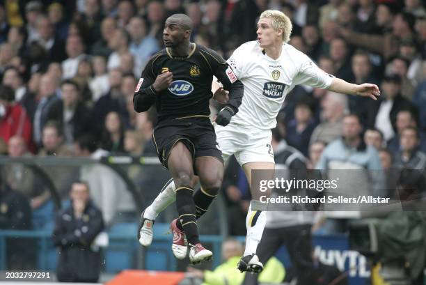 Matthew Kilgallon of Leeds United and Jason Roberts of Wigan Athletic challenge during the Championship match between Leeds United and Wigan Athletic...