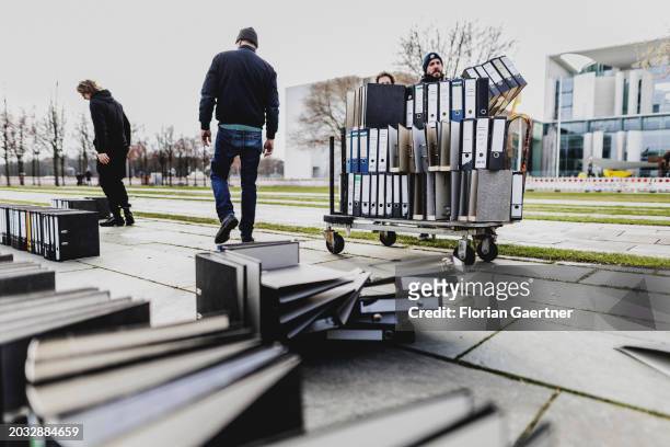 Folders are removed after a protest of the Central Association of German Crafts in front of the Federal Chancellery on February 26, 2024 in Berlin,...