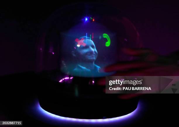 An AI-generated hologram called "Conceptt" flagging a video-call is displayed at the Deutsche Telekom AG's stand during the Mobile World Congress ,...