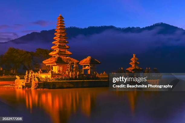 scenic view of ulun danu beratan temple ( pura ulun danu ) on lake bratan or danau beratan in bali , indonesia at dawn - denpasar stock pictures, royalty-free photos & images