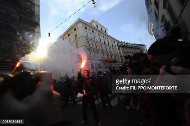 Demonstrator burns a flair during a protest of youths to demand a change of government as parliament met to hold a crucial vote that could topple...
