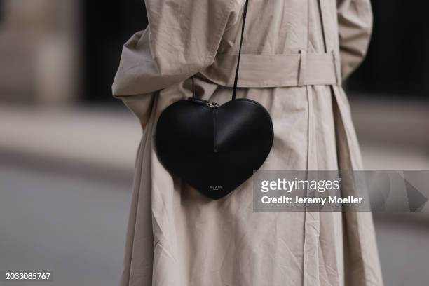 Milena Karl seen wearing The Row beige oversized long coat and Alaia black leather heart shaped crossbody bag, on February 23, 2024 in Hamburg,...