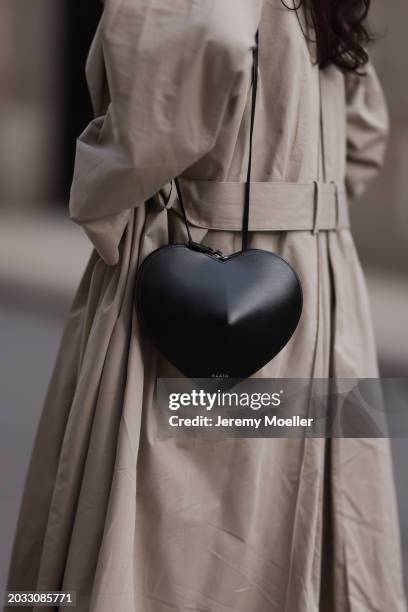 Milena Karl seen wearing The Row beige oversized long coat and Alaia black leather heart shaped crossbody bag, on February 23, 2024 in Hamburg,...