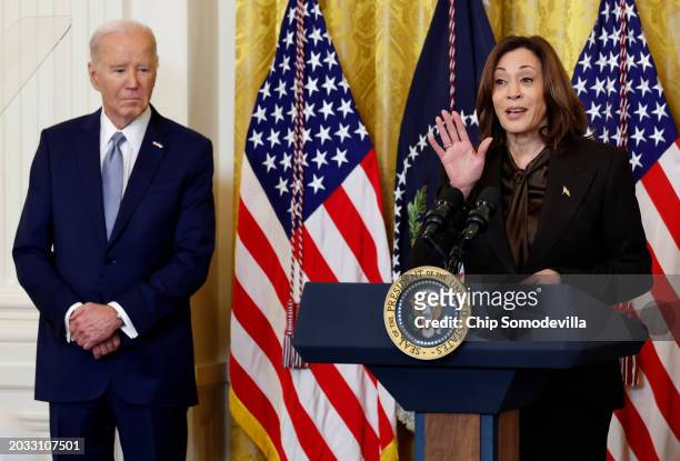 President Joe Biden listens to Vice President Kamala Harris as she addressses governors from across the country during an event in the East Room of...