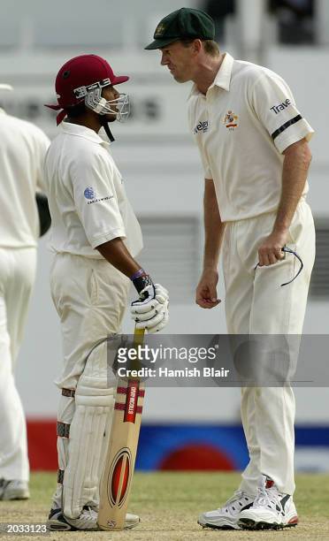 Ramnaresh Sarwan of the West Indies and Glenn McGrath of Australia confront each other during day four of the fourth test between the West Indies and...