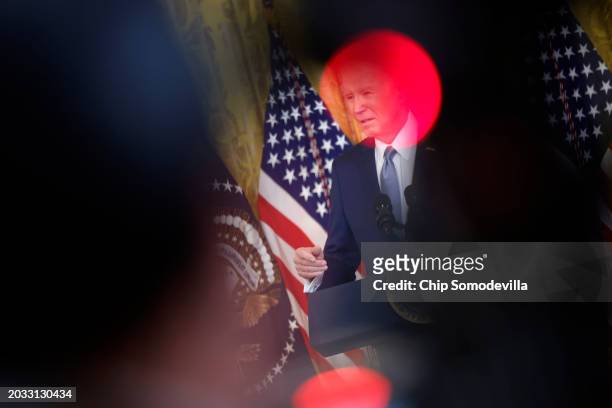 Framed by television camera lights, U.S. President Joe Biden speaks to governors from across the country during an event in the East Room of the...