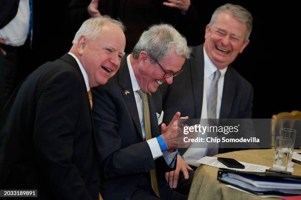 Minnesota Governor Tim Walz, New Jersey Governor Phil Murphy and Idaho Governor Brad Little share a laugh during an event with fellow governors in...
