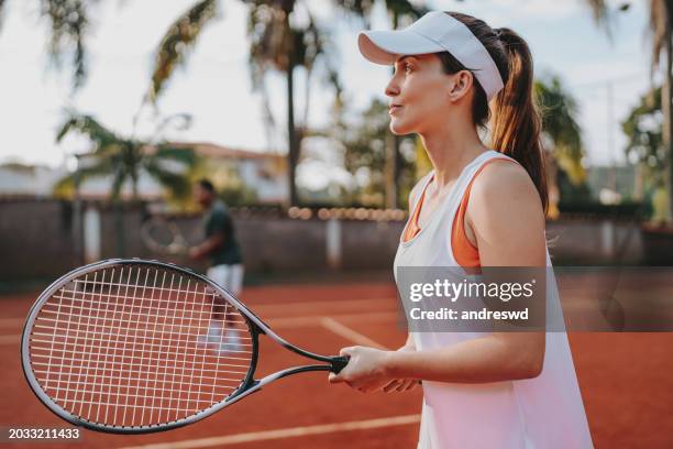 couple playing tennis - bouncing tennis ball stock pictures, royalty-free photos & images