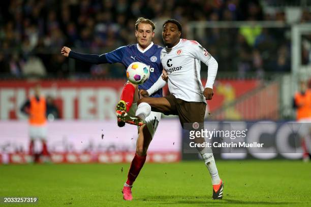 Timo Becker of Holstein Kiel and Oladapo Afolayan of FC St. Pauli battle for possession during the Second Bundesliga match between Holstein Kiel and...