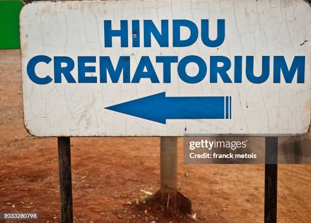 sign announcing a hindu crematorium ( kenya) - crematorium stock pictures, royalty-free photos & images