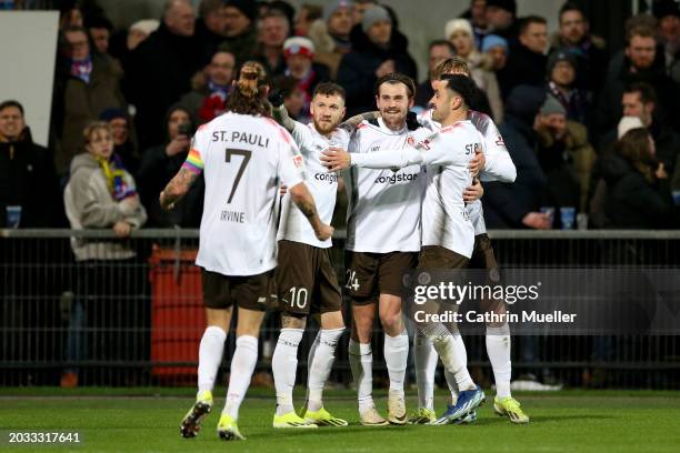 Connor Metcalfe of FC St. Pauli celebrates scoring his team's fourth goal with teammates during the Second Bundesliga match between Holstein Kiel and...