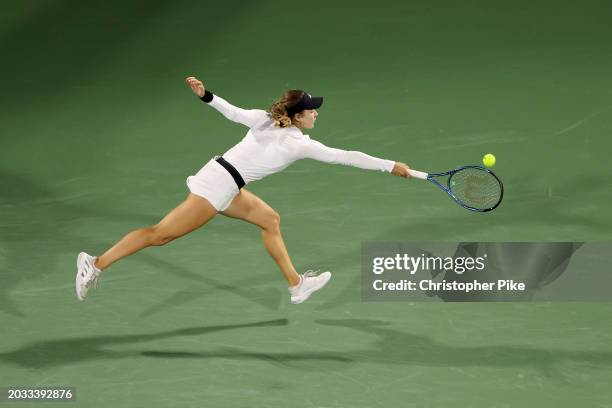 Anna Kalinskaya plays a backhand against Iga Swiatek of Poland in their women's semifinal match during the Dubai Duty Free Tennis Championships, part...