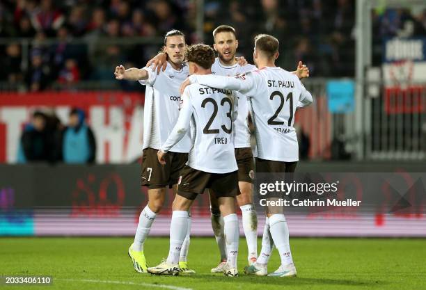 Jackson Irvine, Philipp Treu, Karol Mets and Lars Ritzka of FC St. Pauli celebrate victory in the Second Bundesliga match between Holstein Kiel and...