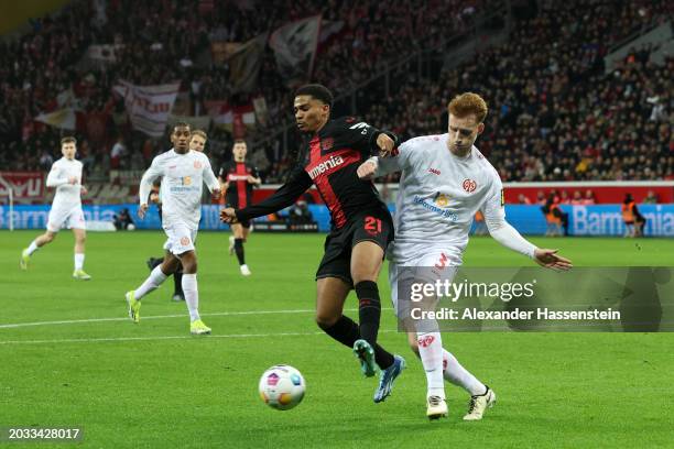 Amine Adli of Bayer Leverkusen is challenged by Sepp van den Berg of 1.FSV Mainz 05 during the Bundesliga match between Bayer 04 Leverkusen and 1....