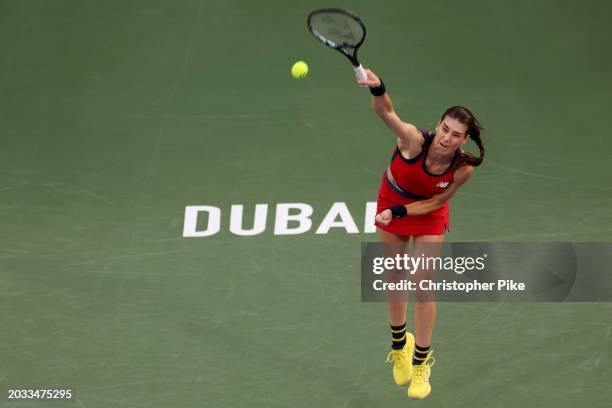 Sorana Cirstea of Romania serves against Jasmine Paolini of Italy in their women's semifinal match during the Dubai Duty Free Tennis Championships,...