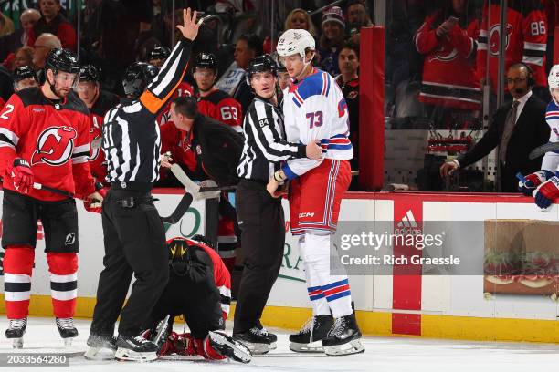 Matt Rempe of the New York Rangers stands over Jonas Siegenthaler of the New Jersey Devils during the game at the Prudential Center on February 22,...