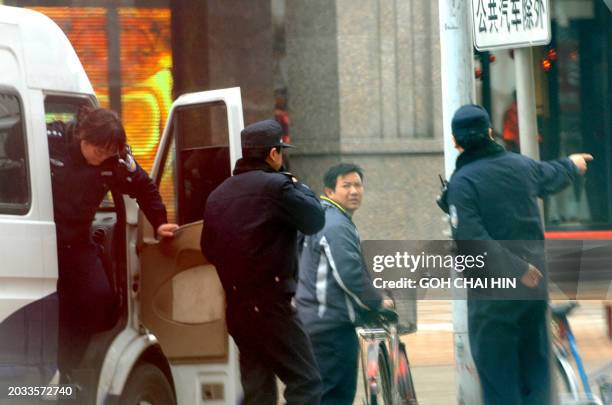 Chinese police man a checkpoint as security is ramped up, with at least 300 hundred uniformed police guarding the entrance to the Jasmine rally site,...