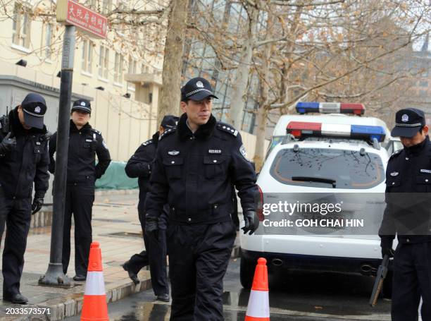 Chinese police man a checkpoint along a street as security is ramped up, with at least 300 hundred uniformed police guarding the entrance to the...