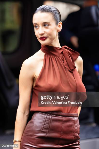 Maria Pedraza is seen wearing a terracotta red halter neck top with a bow detail on the side and a brown leather midi skirt outside Philosophy show...