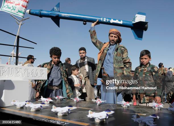 Yemeni protestor carries a mock missile as he takes part in a rally held to support the Palestinian people and against Israel over the sustained war...