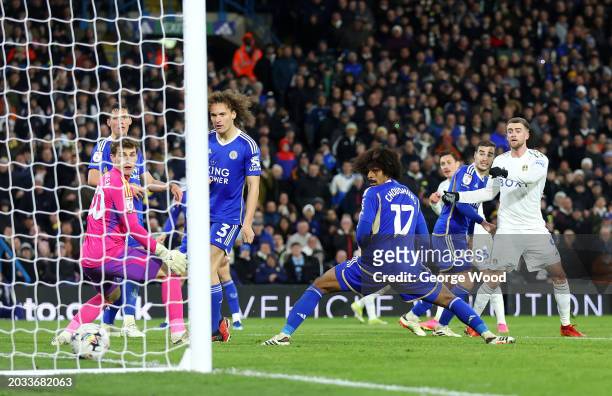 Mads Hermansen, Wout Faes and Hamza Choudhury of Leicester City look on as a shot by Connor Roberts of Leeds United results in Leeds United's first...