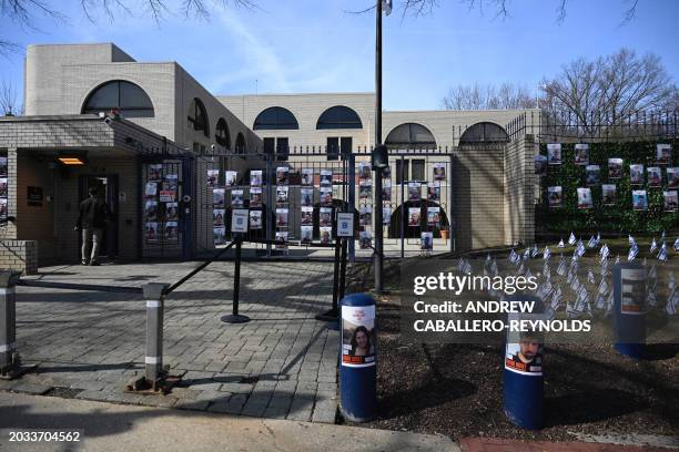 Man enters the Israeli embassy, near pictures of hostages in Gaza, in Washington, DC, on February 26, 2024. UN Secretary-General Antonio Guterres...