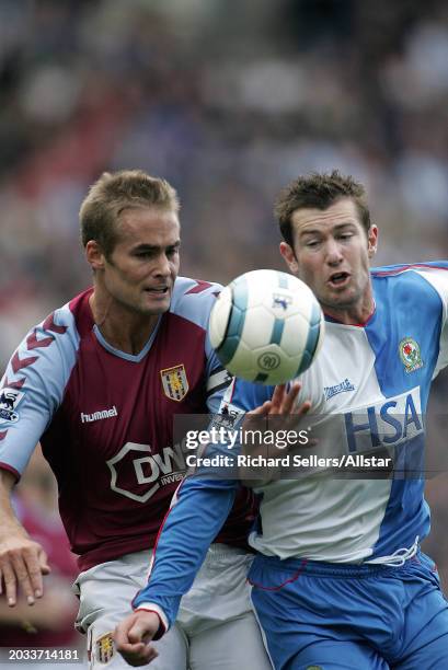 Olof Mellberg of Aston Villa and Brett Emerton of Blackburn Rovers challenge during the Premier League match between Blackburn Rovers and Aston Villa...